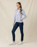 Woman wearing the Marlow Jacket in Cosmic Blue with navy golf pants