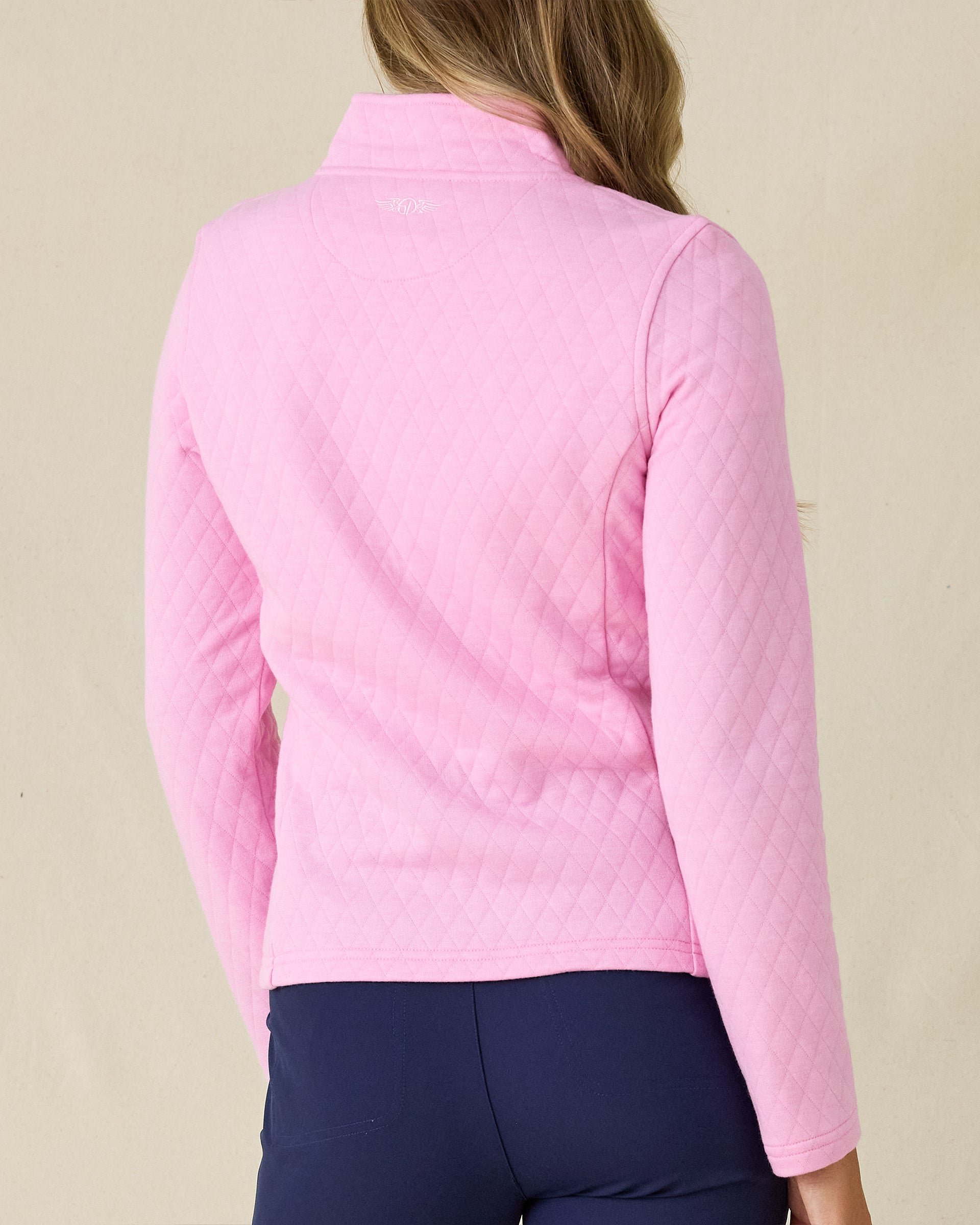 Marlow Jacket in Pink Floyd, back view on model in solid pink diamond quilt texture with Straight Down logo embroidered at center back, paired with navy pants