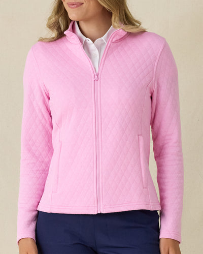Marlow Jacket in Pink Floyd, front view on model in solid pink diamond quilt texture with full zip, layered over a white polo, paired with navy pants