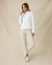 Women's Marlow Jacket in White, full-length side view on model featuring a full-zip closure and diamond quilted texture pattern, styled with a white collared shirt, khaki pants, and white shoes