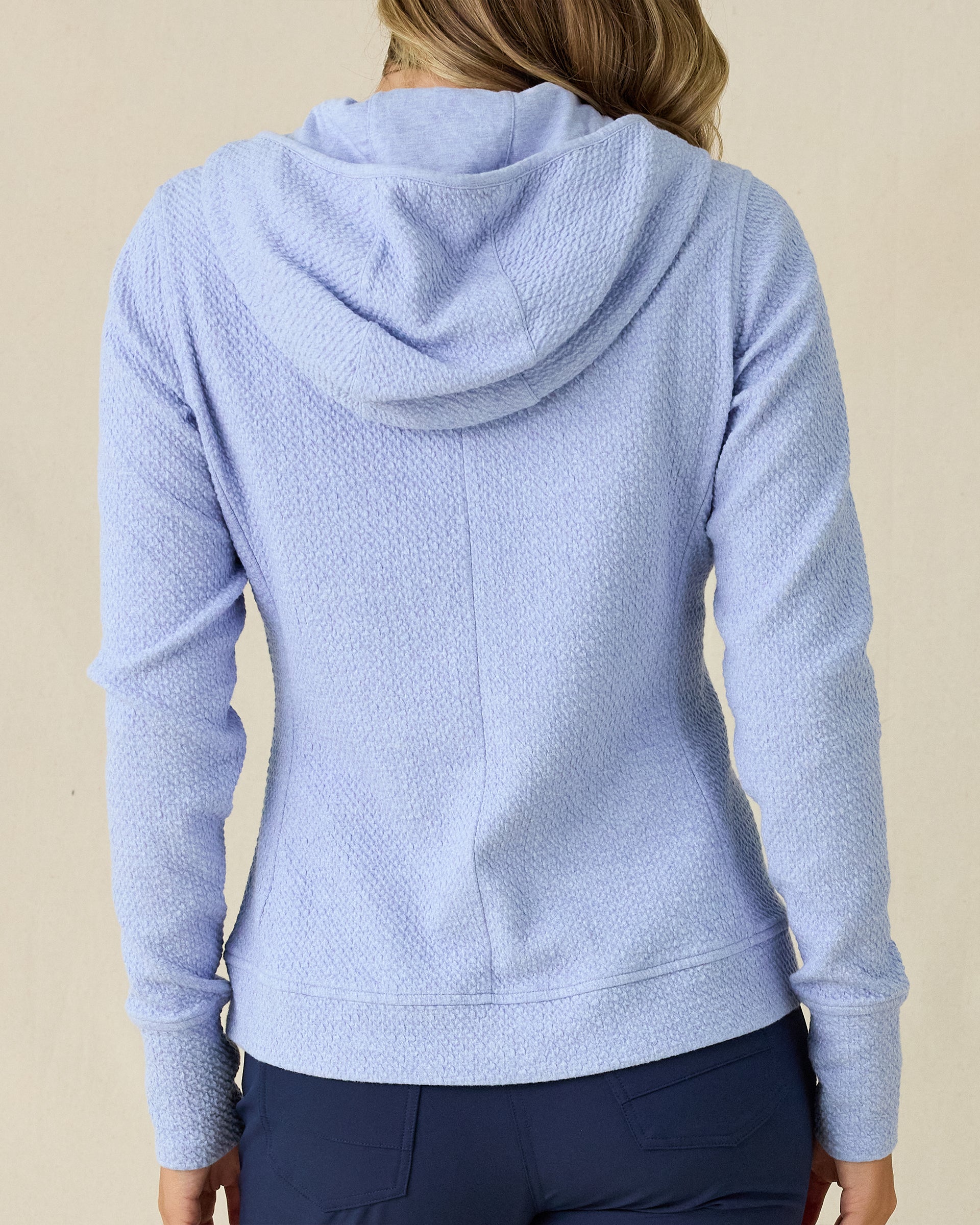 Highland Hooded Jacket in Blue Heather, back view on model in solid light blue textured fleece with hood, paired with navy pants