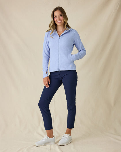 Highland Hooded Jacket in Blue Heather, full-length front view on model in solid light blue textured fleece with full zip and hood, paired with navy pants and white golf shoes