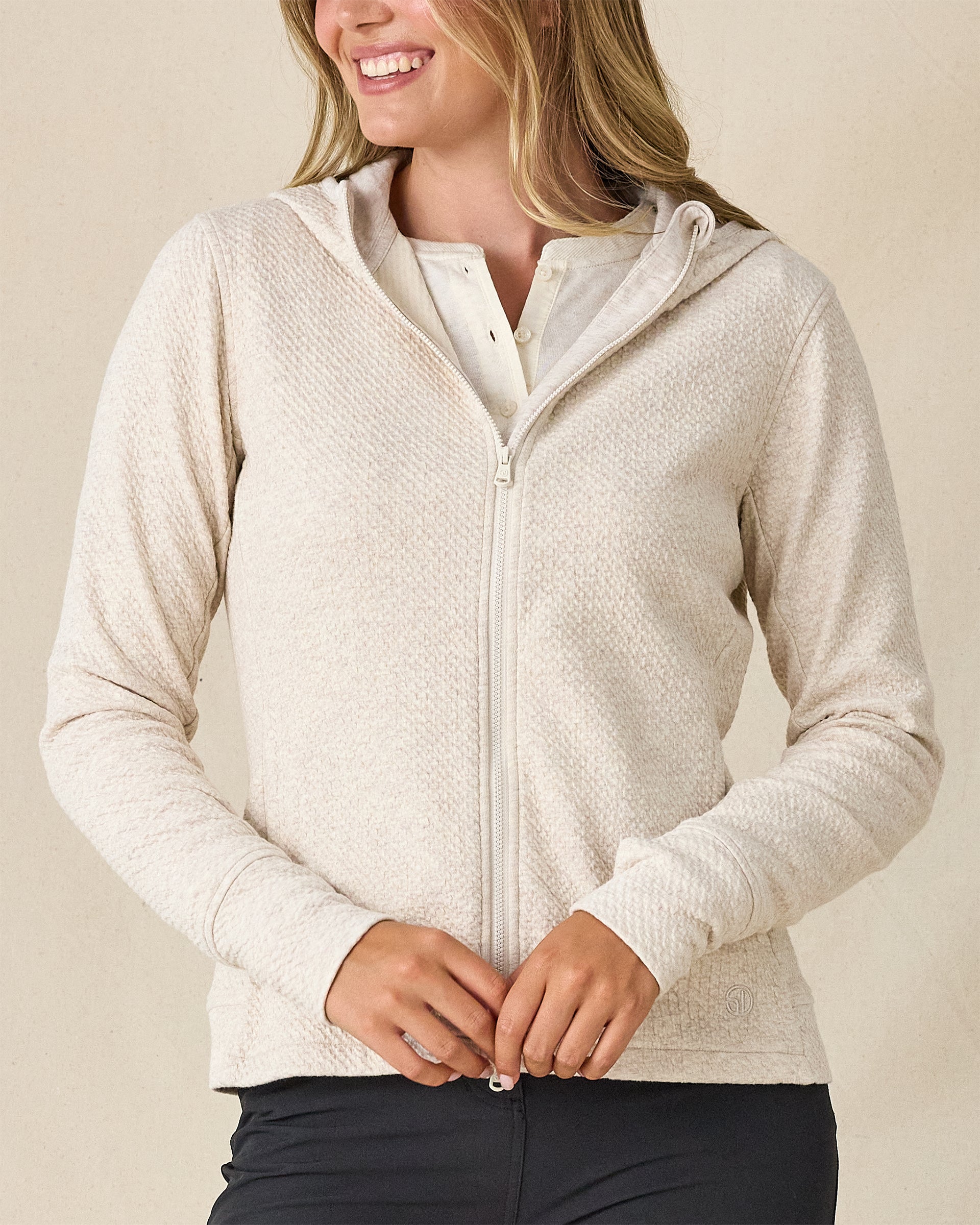 Highland Hooded Jacket in Oatmeal Heather, front view on model featuring an oatmeal heather textured fleece full zip hooded jacket, layered over a white polo and paired with charcoal pants