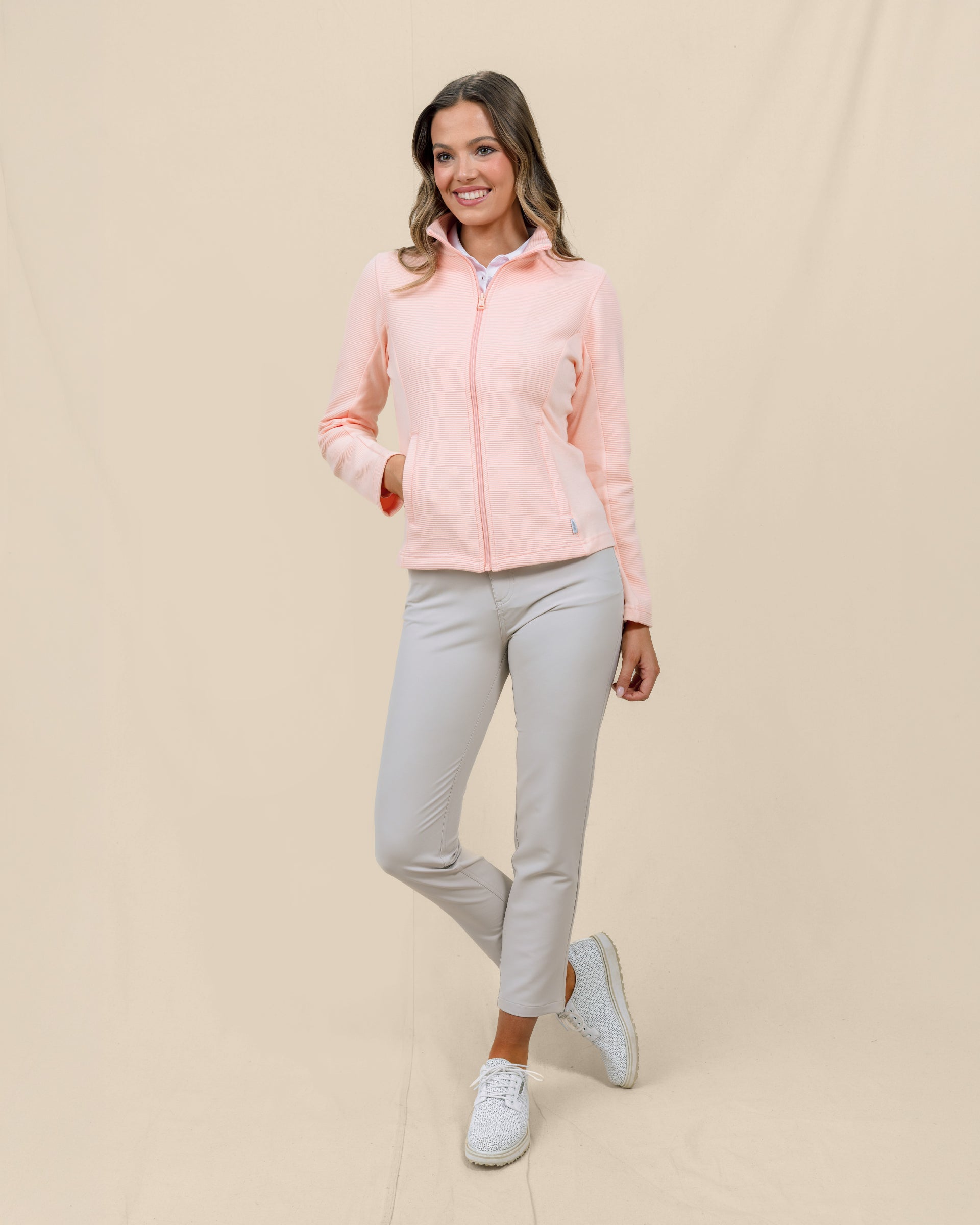Full-length front view of a model wearing the New Swing Jacket in Melba zipped with one hand in the front pocket.