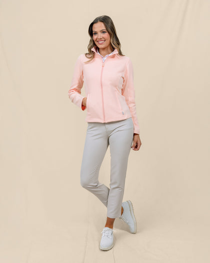 Full-length front view of a model wearing the New Swing Jacket in Melba zipped with one hand in the front pocket.
