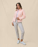 Full-length view of a model wearing the New Swing Jacket in Melba open over a white polo with light-colored pants and golf shoes.