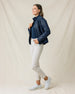 Woman wearing the Straight Down Taylor Jacket in New Indigo with light golf pants in a side profile