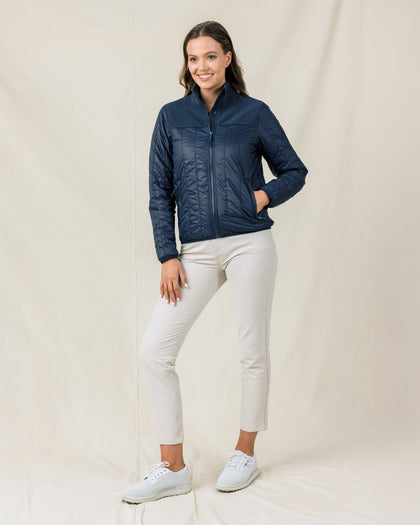 Woman wearing the Straight Down Taylor Jacket in New Indigo with light golf pants