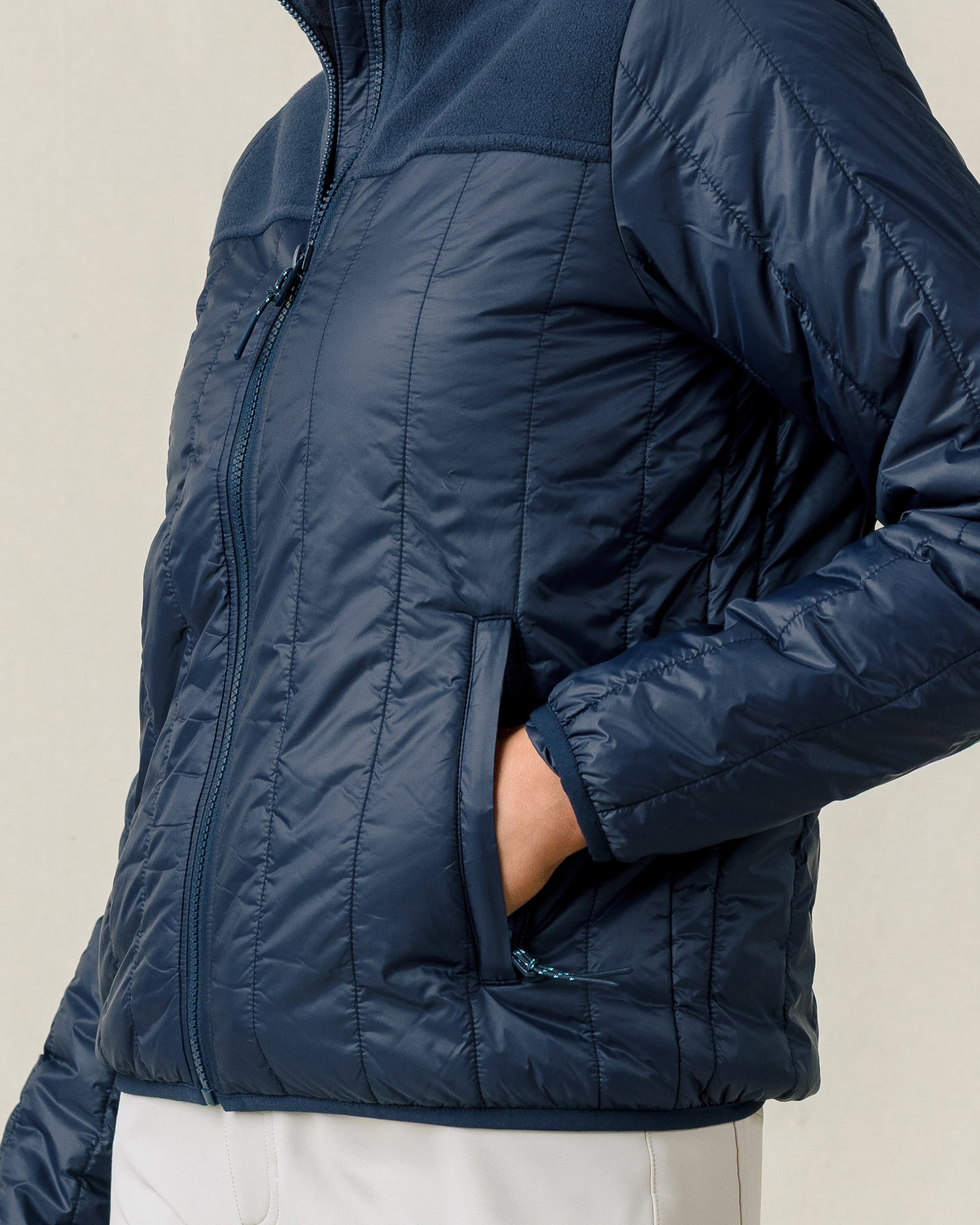 Close-up of the Taylor Jacket in New Indigo featuring quilted insulation and zip hand pockets