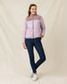 Model wearing the Taylor Jacket in Pink Dawn zipped with navy golf pants