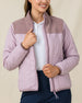 Close-up of the Taylor Jacket in Pink Dawn worn unzipped, highlighting the quilted front, fleece yoke, and full-zip design