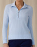 Women's Hills Quarter Zip in Lake, front view on model featuring a light blue waffle-knit quarter-zip pullover with mock neck collar and silver zipper hardware, paired with navy pants