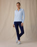 Women's Hills Quarter Zip in Lake, full length front angle view on model featuring a light blue waffle-knit quarter-zip pullover with mock neck collar and Straight Down logo patch at the hem, paired with navy pants and white golf shoes
