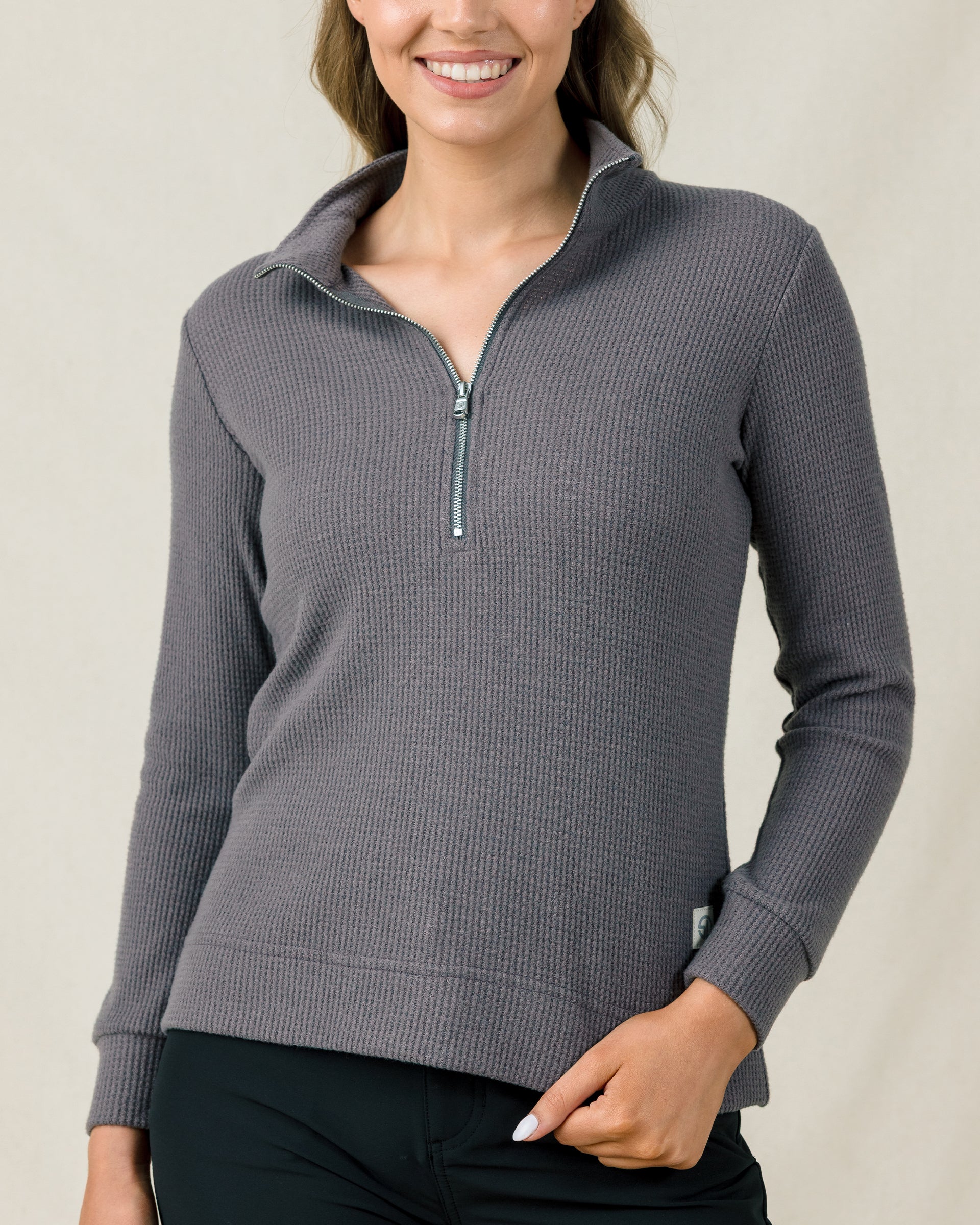 Woman wearing the Hills Quarter Zip in Nightshade, showcasing the textured waffle knit fabric and quarter-zip collar.