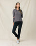 Woman wearing the Hills Quarter Zip in Nightshade with black pants and white golf shoes.