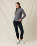 Woman wearing the Hills Quarter Zip in Nightshade, styled with black pants and white golf shoes.