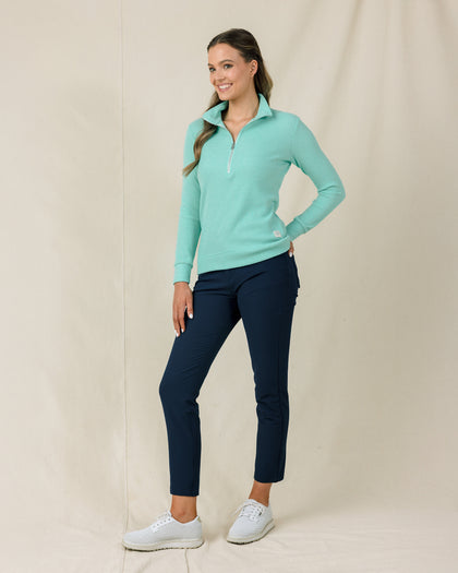 Model wearing the Cascade Hills Quarter Zip with navy performance pants and white golf shoes
