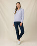 Woman wearing the Straight Down Hills Quarter Zip in Cosmic Blue with the collar open, paired with navy golf pants