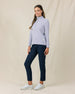 Woman wearing the Straight Down Hills Quarter Zip in Cosmic Blue with the quarter zip fully closed, paired with navy golf pants