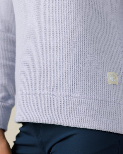 Close-up of the Straight Down Hills Quarter Zip in Cosmic Blue highlighting the soft waffle knit fabric and signature logo hem patch