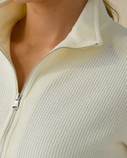 Women's Hills Quarter Zip in Cream, close-up detail view featuring the waffle knit texture, stand collar, and silver quarter zip on a cream pullover