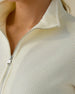 Women's Hills Quarter Zip in Cream, close-up detail view featuring the waffle knit texture, stand collar, and silver quarter zip on a cream pullover