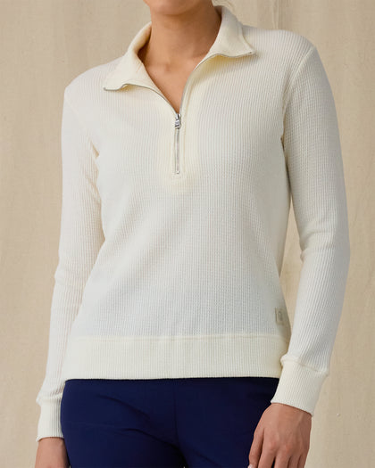 Women's Hills Quarter Zip in Cream, front view on model featuring a cream long sleeve quarter zip pullover with a waffle knit texture and stand collar, paired with navy pants