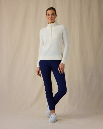 Women's Hills Quarter Zip in Cream, full length front view on model featuring a cream long sleeve quarter zip pullover with a waffle knit texture, paired with navy pants and white golf shoes