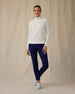 Women's Hills Quarter Zip in Cream, full length front view on model featuring a cream long sleeve quarter zip pullover with a waffle knit texture, paired with navy pants and white golf shoes