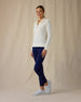Women's Hills Quarter Zip in Cream, full length side angle view on model featuring a cream long sleeve quarter zip pullover with a waffle knit texture, paired with navy pants and white golf shoes
