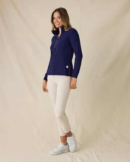 Women's Hills Quarter Zip in New Indigo, full-length side view on model featuring a navy quarter-zip closure and waffle knit texture, styled with khaki pants and white shoes