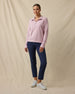 Woman wearing the Collette Quarter Zip in Pink Dawn partially unzipped with navy golf pants