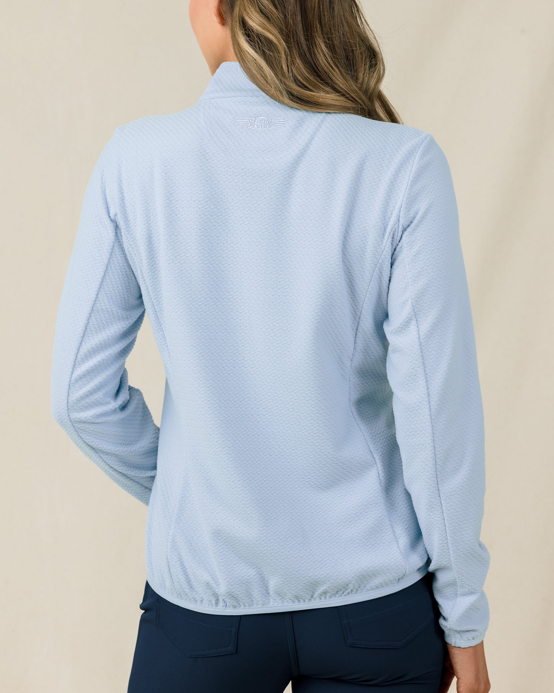 Back view of the Lorna Half Zip in Lake, highlighting the textured knit and embroidered Straight Down logo below the collar.