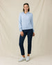 Woman wearing the Lorna Half Zip in Lake with navy pants and white golf shoes.