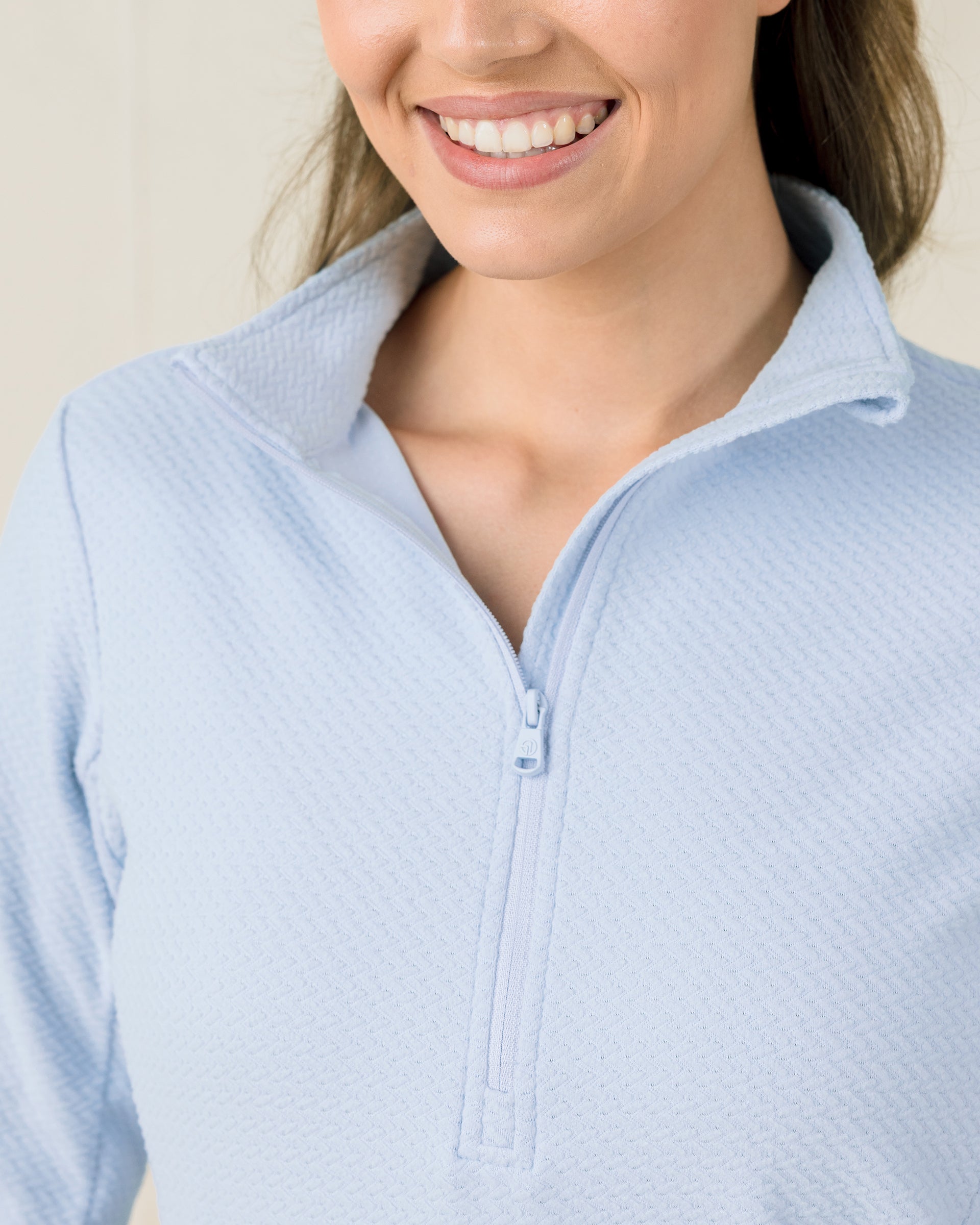 Close-up of the Lorna Half Zip in Lake highlighting the textured fabric, half-zip neckline, and collar construction.