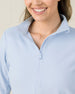 Close-up of the Lorna Half Zip in Lake highlighting the textured fabric, half-zip neckline, and collar construction.