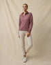Model wearing the Lorna Half Zip in Oxblood Red with cream golf pants, collar unzipped