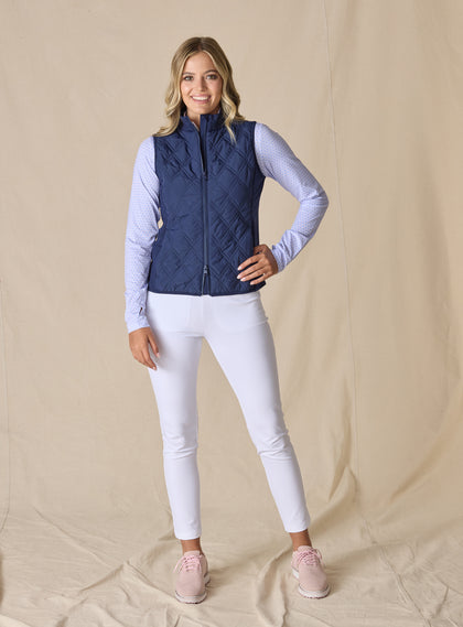 Women's Hestia Vest in New Indigo, full length front view on model featuring a solid navy quilted diamond pattern and full zip closure