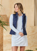 Women's Hestia Vest in New Indigo, front view on model featuring a solid navy quilted diamond pattern styled open over a light blue layer