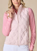 Women's Hestia Vest in Soft Pink, front view on model featuring a solid light pink quilted diamond pattern and full zip closure