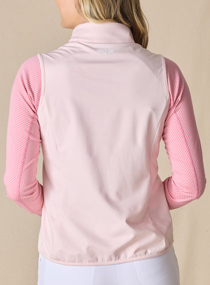 Women's Hestia Vest in Soft Pink, back view on model featuring a solid light pink stretch back panel with white embroidered Straight Down wings logo