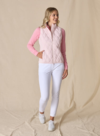 Women's Hestia Vest in Soft Pink, full length front view on model featuring a solid light pink quilted diamond pattern and full zip closure