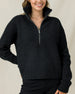 Woman wearing the Devon Half Zip Sweater in Charcoal, showing the relaxed fit, ribbed texture, and high zip collar.