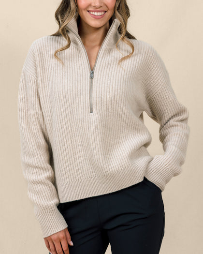 Woman wearing the Devon Half Zip Sweater in Oat, showing the relaxed fit, ribbed texture, and high zip collar.
