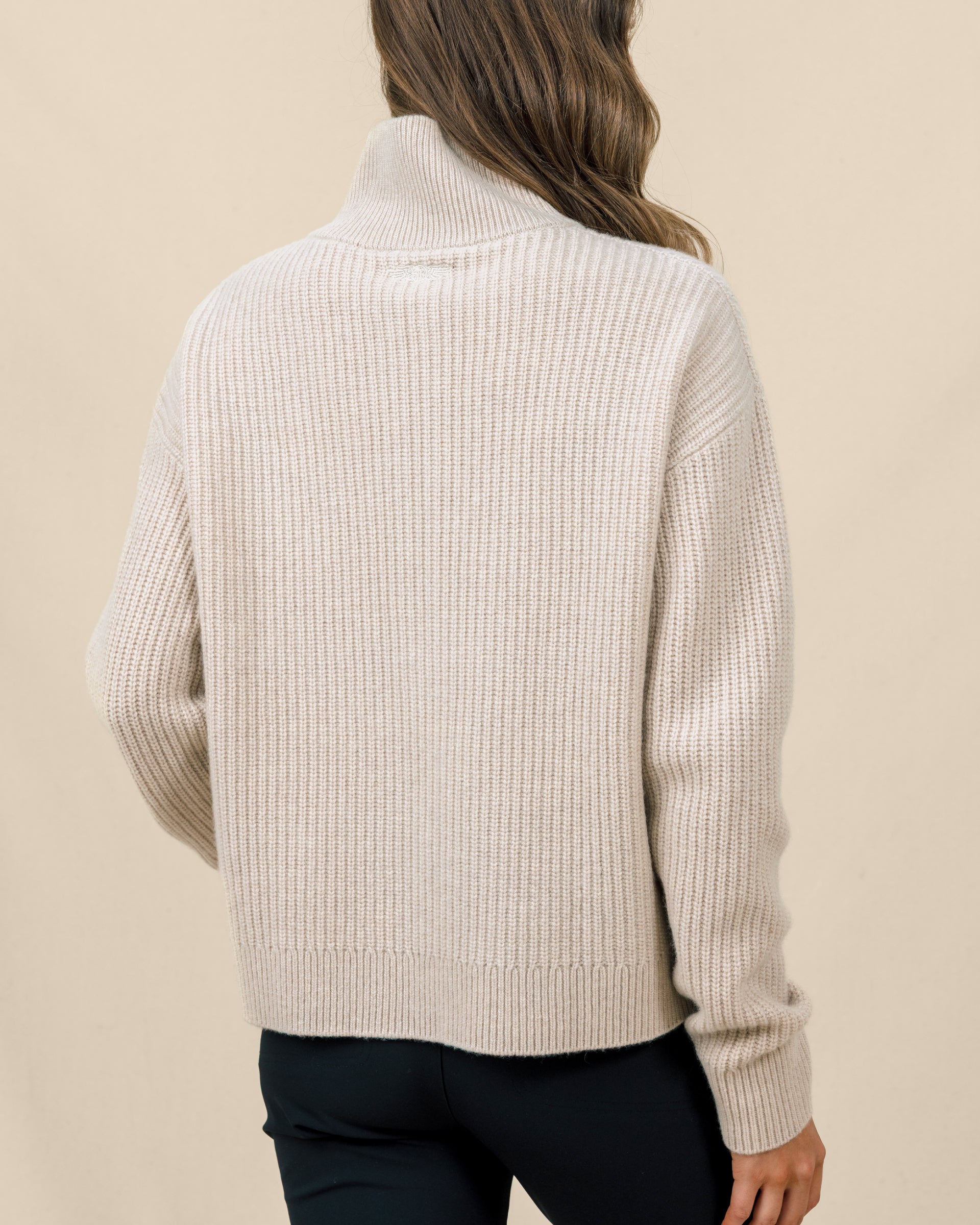 Back view of the Devon Half Zip Sweater in Oat, highlighting the relaxed silhouette, ribbed knit, and high collar.