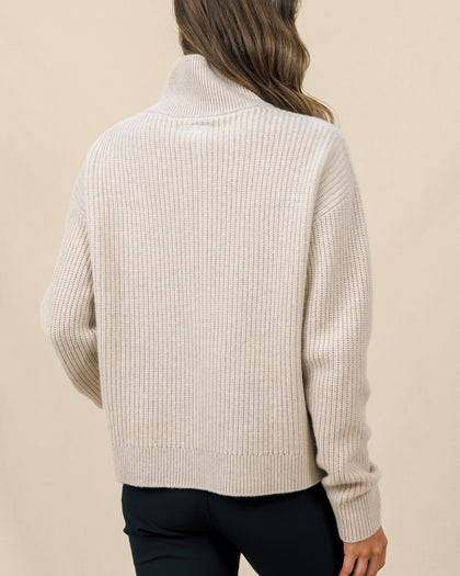 Back view of the Devon Half Zip Sweater in Oat, highlighting the relaxed silhouette, ribbed knit, and high collar.