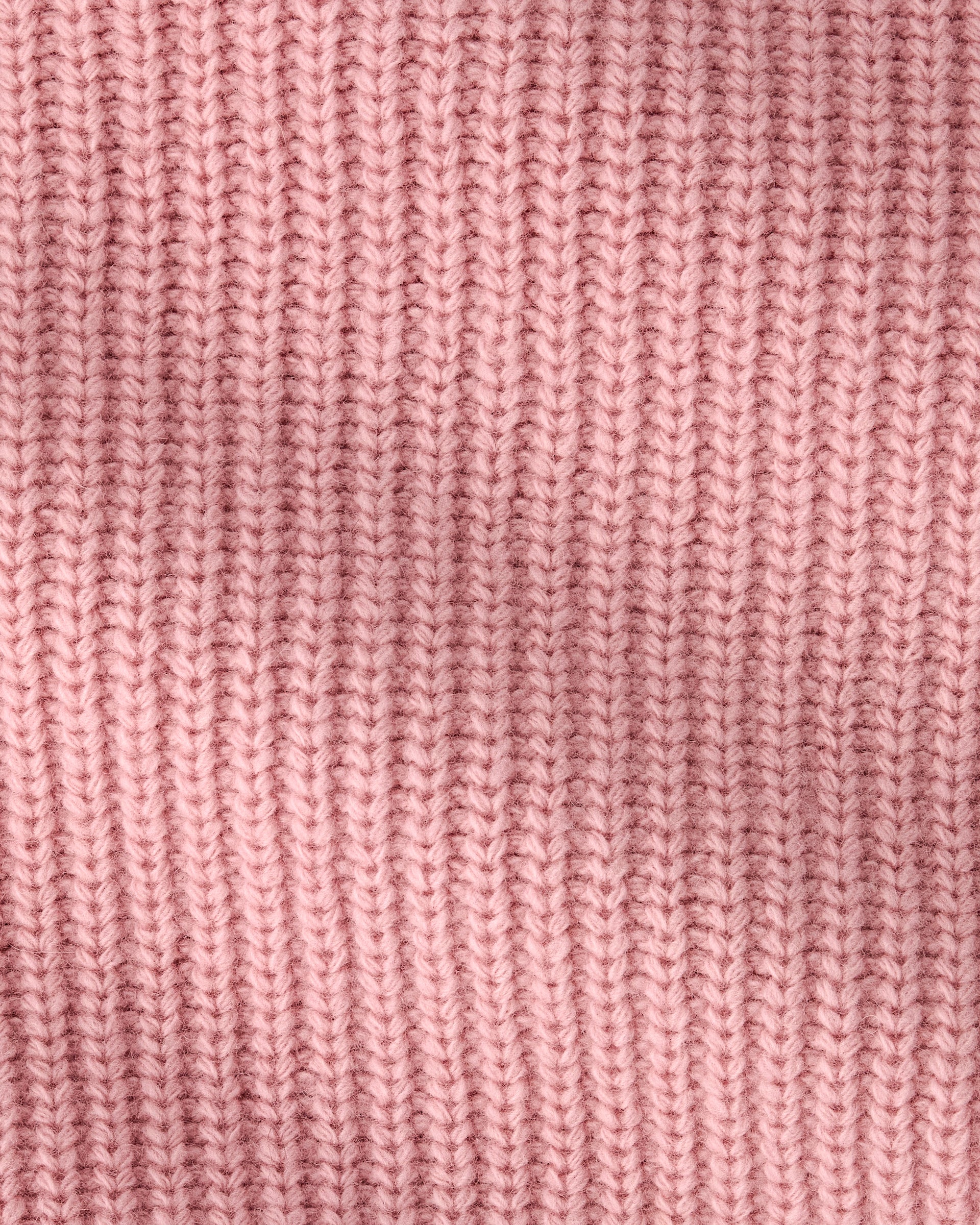 A close-up of a pink ribbed knit fabric texture, showing the detailed vertical rows of the knit pattern.