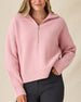 Women's Devon Half Zip Sweater in Rose, front view on model featuring a pink quarter-zip closure and ribbed knit texture, styled with black pants