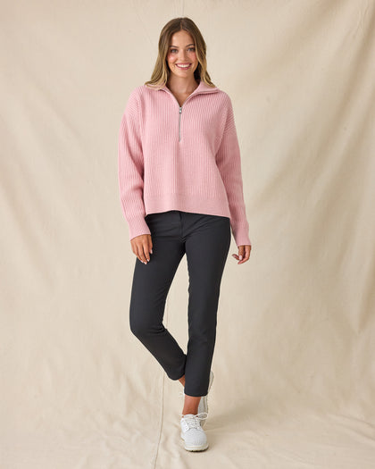Women's Devon Half Zip Sweater in Rose, full-length front view on model featuring a pink quarter-zip closure and ribbed knit texture, styled with black pants and white shoes