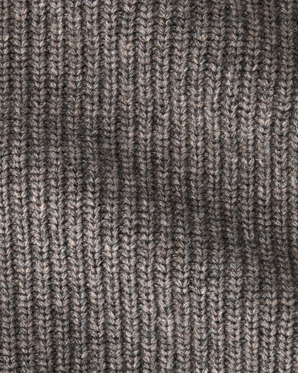 Close-up of a ribbed knit fabric in a heathered taupe-brown and gray colorway, showing the detailed texture of the yarn and stitching.